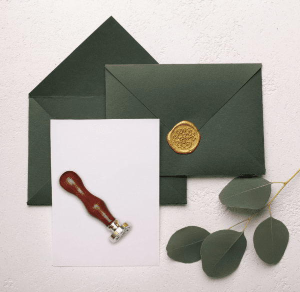 Green envelopes with a wax seal and stamp.